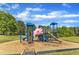 A vibrant playground with climbing structures and slides offers children an engaging and active play environment at 604 Young Forest Dr, Wake Forest, NC 27587