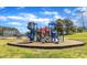 Colorful playground equipment, including slides and climbing structures, offers an engaging play area under a bright sky at 604 Young Forest Dr, Wake Forest, NC 27587