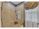 Walk-in shower features tiled walls, a glass enclosure, and a built-in wooden seat at 604 Young Forest Dr, Wake Forest, NC 27587