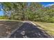 Scenic walking trail surrounded by lush trees and greenery under a bright blue sky at 604 Young Forest Dr, Wake Forest, NC 27587