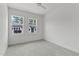 Bright bedroom features plush carpet and natural light from two windows at 6406 Tanner Oak Ln, Raleigh, NC 27613
