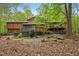 Two-story home with mature trees and a large wooden deck in backyard setting at 673 Brookview Dr, Chapel Hill, NC 27514