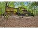 Wood home featuring an expansive backyard with mature trees and a wooden deck at 673 Brookview Dr, Chapel Hill, NC 27514