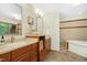 Bright bathroom features double sinks, warm toned tile floors, and a separate tub and shower at 673 Brookview Dr, Chapel Hill, NC 27514