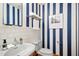 Stylish bathroom featuring blue striped walls, white subway tile, and modern fixtures at 673 Brookview Dr, Chapel Hill, NC 27514