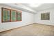 Bright bedroom features neutral carpet, paint, trim and natural light from two wood framed windows at 673 Brookview Dr, Chapel Hill, NC 27514