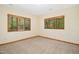 Bright bedroom features neutral carpet, paint, trim and natural light from two wood framed windows at 673 Brookview Dr, Chapel Hill, NC 27514