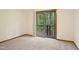 Bedroom with gray carpet and sliding glass doors leading to a deck with wooded views at 673 Brookview Dr, Chapel Hill, NC 27514