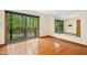 Bright bedroom with hardwood floors and sliding doors to a deck, alongside a mirrored wall at 673 Brookview Dr, Chapel Hill, NC 27514