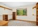 Walk-in closet with custom wood shelving and a window with tree views at 673 Brookview Dr, Chapel Hill, NC 27514