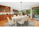 Open dining area with wood floors flows into kitchen with stainless appliances and backyard views at 673 Brookview Dr, Chapel Hill, NC 27514