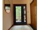 A modern front door with sidelights and a view to the outside complements the interior design and welcomes guests at 673 Brookview Dr, Chapel Hill, NC 27514