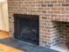 A brick fireplace with a black screen enhances the charm of the living space, blending classic and modern elements at 673 Brookview Dr, Chapel Hill, NC 27514