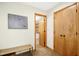 Hallway with bench seating leading to a bathroom, enhanced by natural wood trim at 673 Brookview Dr, Chapel Hill, NC 27514