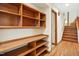 Hallway with hardwood floors, built in shelving, and a staircase to another floor at 673 Brookview Dr, Chapel Hill, NC 27514