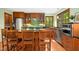 Spacious kitchen with stainless appliances, eat-in island and bright green walls overlooking the back yard at 673 Brookview Dr, Chapel Hill, NC 27514