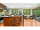 Kitchen with wood cabinets, island seating, stainless appliances and bright green walls with views of the backyard at 673 Brookview Dr, Chapel Hill, NC 27514