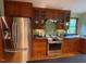Updated kitchen boasts stainless steel appliances, wood cabinets, and sleek black countertops at 673 Brookview Dr, Chapel Hill, NC 27514