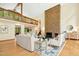 An airy living room with a brick fireplace, wall of windows, and stylish furniture creates an inviting space at 673 Brookview Dr, Chapel Hill, NC 27514