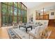 An airy living room with a wall of windows and stylish furniture creates an inviting space at 673 Brookview Dr, Chapel Hill, NC 27514
