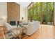 Spacious living room with a brick fireplace, wall of windows, and stylish furniture creating an inviting space at 673 Brookview Dr, Chapel Hill, NC 27514