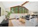 Bright living room with large windows, comfortable seating, and stylish decor at 673 Brookview Dr, Chapel Hill, NC 27514