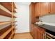 Spacious pantry with custom wood shelving, cabinets, and black countertop at 673 Brookview Dr, Chapel Hill, NC 27514