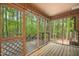 Screened porch with wood floors has views of surrounding green trees and nature at 673 Brookview Dr, Chapel Hill, NC 27514