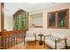 Cozy sitting area with vaulted ceilings, large windows, and hardwood floors, with a wooded view at 673 Brookview Dr, Chapel Hill, NC 27514