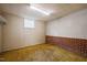 Finished basement area with carpet flooring and wood paneling with painted brick at 6804 Justice Dr, Raleigh, NC 27615