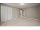 Neutral bedroom with carpeted floors, closet with louvered doors and an open doorway to another room at 6804 Justice Dr, Raleigh, NC 27615