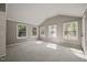 Sun-drenched bedroom featuring neutral walls, carpet, and multiple windows providing a panoramic outdoor view at 6804 Justice Dr, Raleigh, NC 27615