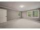 A serene bedroom featuring neutral decor, plush carpet, and abundant natural light from large windows at 6804 Justice Dr, Raleigh, NC 27615
