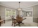 Traditional dining room with natural light streaming through large windows at 6804 Justice Dr, Raleigh, NC 27615