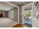 Foyer with hardwood flooring, open living space, window with natural light and glass-paneled storm door at 6804 Justice Dr, Raleigh, NC 27615