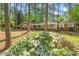 Charming brick home with a welcoming front porch surrounded by lush landscaping and mature trees at 6804 Justice Dr, Raleigh, NC 27615