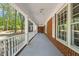 Spacious covered front porch with white railings and brick accents, offering a comfortable outdoor space at 6804 Justice Dr, Raleigh, NC 27615