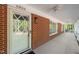 Covered front porch of a red brick home with a white door and ample natural light at 6804 Justice Dr, Raleigh, NC 27615