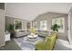 Spacious living room with ample seating, large windows, and neutral tones for a serene atmosphere at 6804 Justice Dr, Raleigh, NC 27615