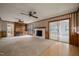 Cozy living room featuring a brick fireplace and sliding glass doors at 6804 Justice Dr, Raleigh, NC 27615