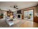 Cozy living room with a fireplace, built-in shelves, and sliding glass doors to an adjoining living space at 6804 Justice Dr, Raleigh, NC 27615