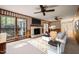 Inviting living room with a brick fireplace, large windows, and views of the surrounding landscape at 6804 Justice Dr, Raleigh, NC 27615