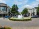 A town center with upscale shops, a central fountain, and landscaped pedestrian areas at 6804 Justice Dr, Raleigh, NC 27615