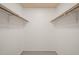 An organized walk-in closet featuring wooden rails providing ample storage and functionality at 6804 Justice Dr, Raleigh, NC 27615