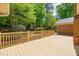 View of the wooden deck that overlooks the wooded backyard and serene green landscaping at 7 Dubarry Ct, Durham, NC 27705