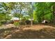 Expansive backyard showcasing the main house and an outbuilding at 7 Dubarry Ct, Durham, NC 27705