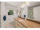 Well-lit bathroom with granite countertop, white cabinets, and shower/tub at 7 Dubarry Ct, Durham, NC 27705