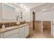 This primary bath offers a dual vanity with a granite countertop and a tiled standup shower at 7 Dubarry Ct, Durham, NC 27705