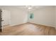 Spacious bedroom with lovely wood-look floors, a ceiling fan, and a large window at 7 Dubarry Ct, Durham, NC 27705