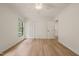 Bright bedroom features wood-look flooring, fresh paint, and natural light from a large window at 7 Dubarry Ct, Durham, NC 27705
